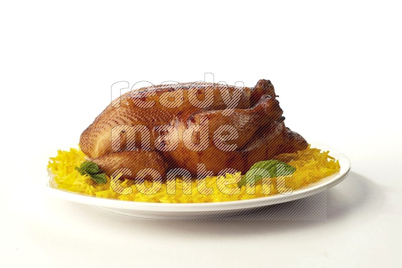 yellow  basmati Rice with  whole roasted chicken on a white rounded plate direct on white background