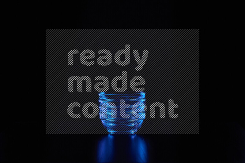 Glassware with rim light in blue against black background