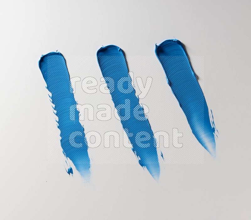 Blue painting knife strokes on white background