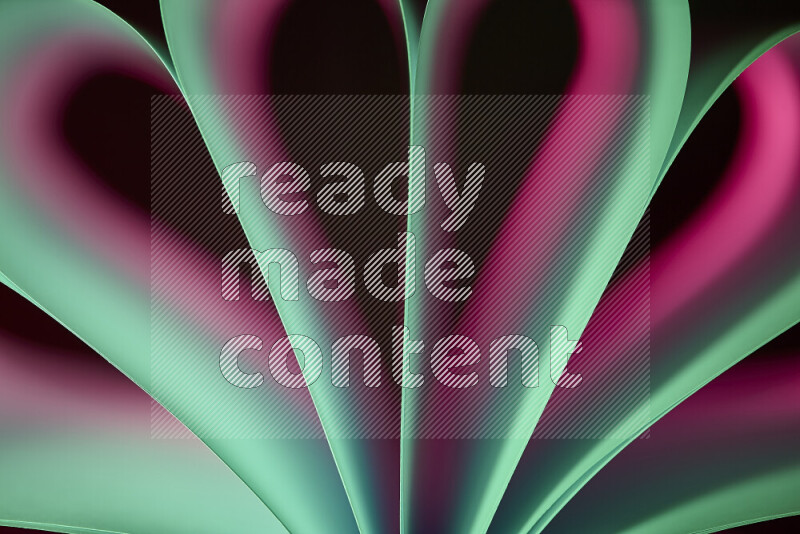 An abstract art piece displaying smooth curves in pink and green gradients created by colored light