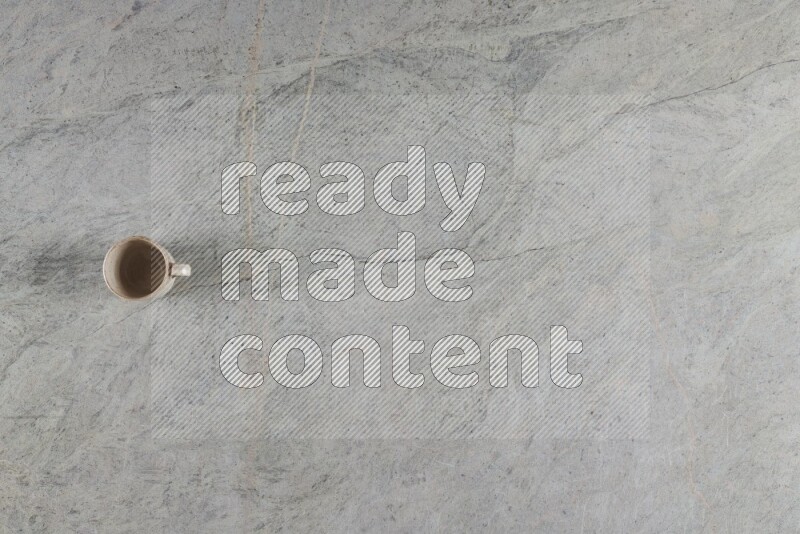 A multicolored pottery Cup on grey marble background