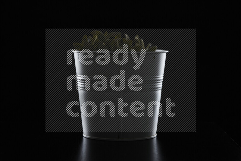 A plant pot with colored rim light against black background