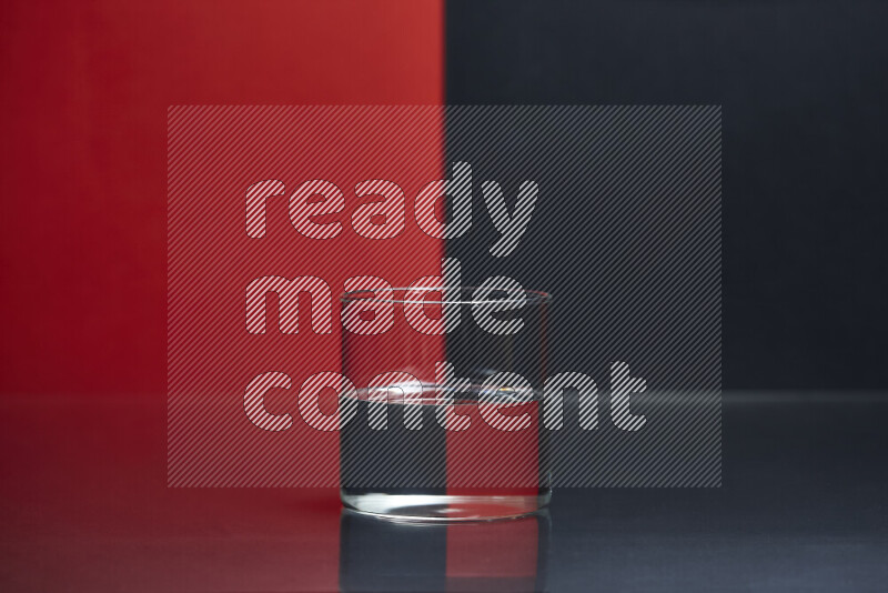 The image features a clear glassware filled with water, set against red and black background