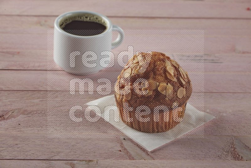 Almond cupcake on a wooden pink background