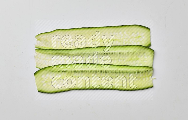Three cucumber ribbons on a white background