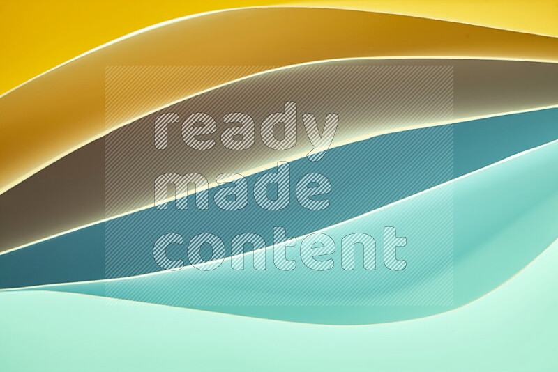 This image showcases an abstract paper art composition with paper curves in green and yellow gradients created by colored light