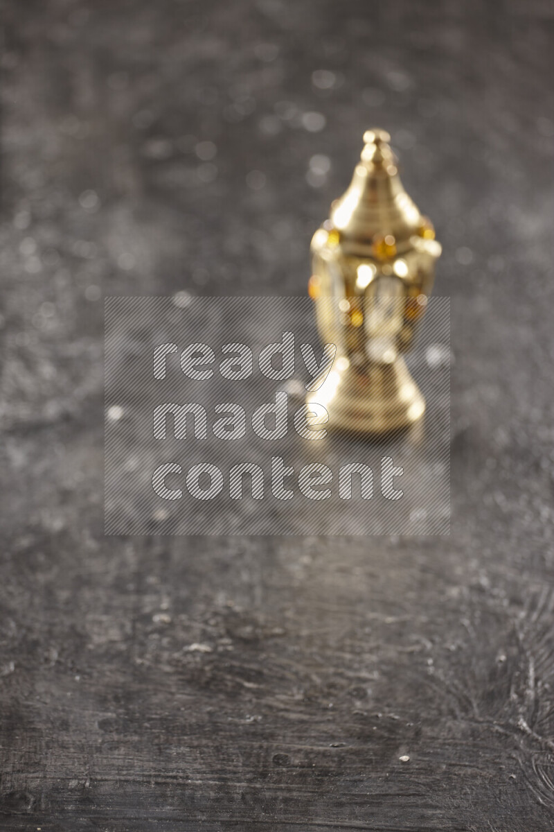 A lantern placed on a textured black background