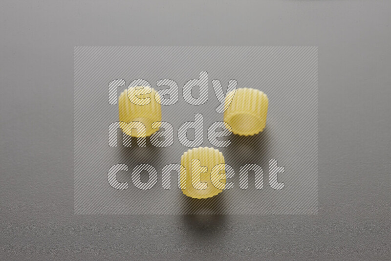 Big rings pasta on grey background