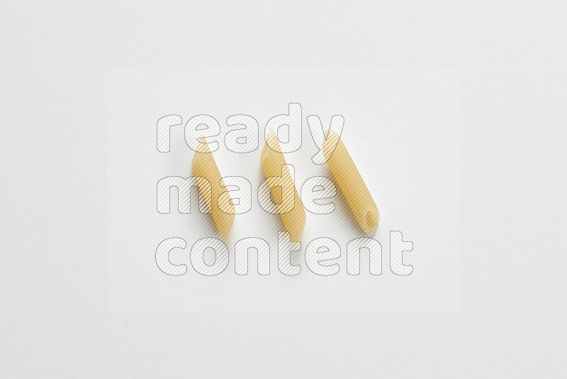 Mini penne pasta on white background