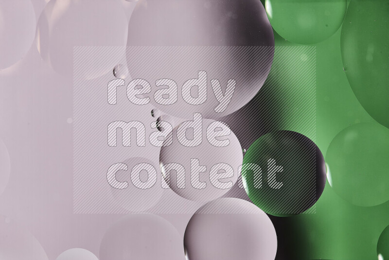 Close-ups of abstract oil bubbles on water surface in shades of white and green