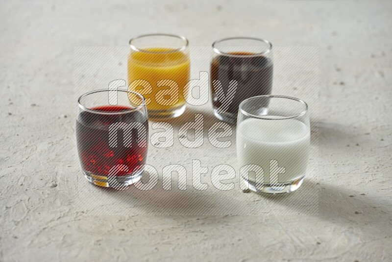 Cold drinks in a glass cup such as water, tamarind, qamar eldin, sobia, milk and hibiscus on textured white background