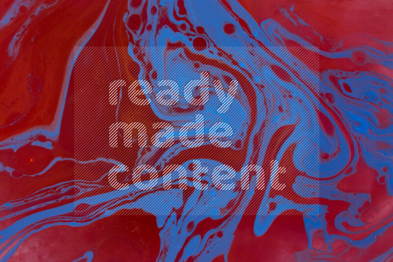 The image depicts a marbling effect with swirling patterns of red and blue
