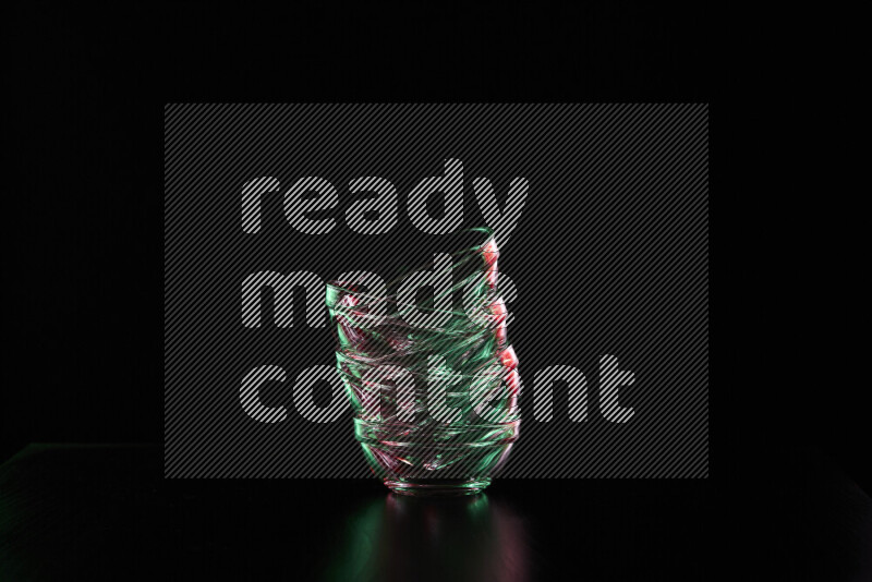 Glassware with rim light in red and green against black background