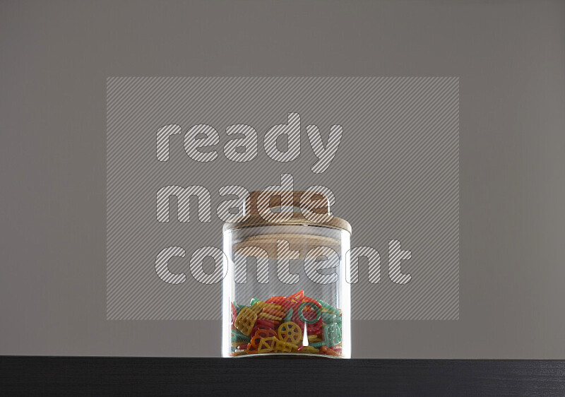 Snacks in a glass jar on black background