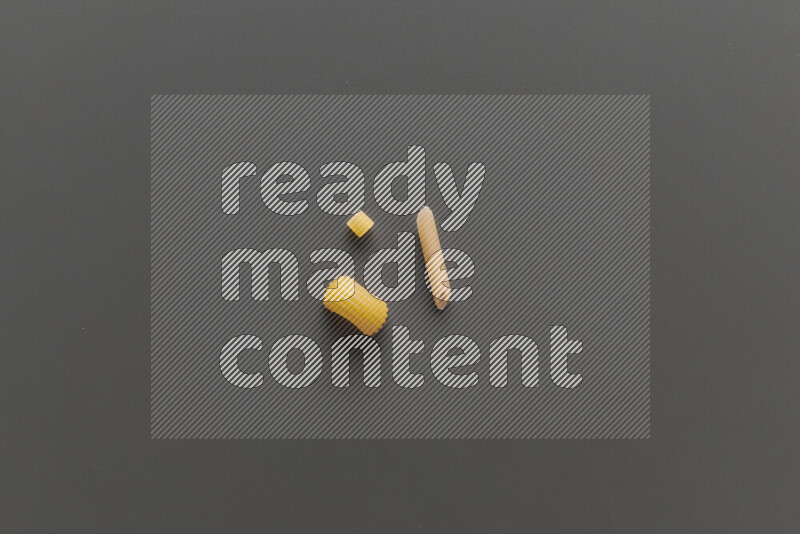 Different pasta types on grey background