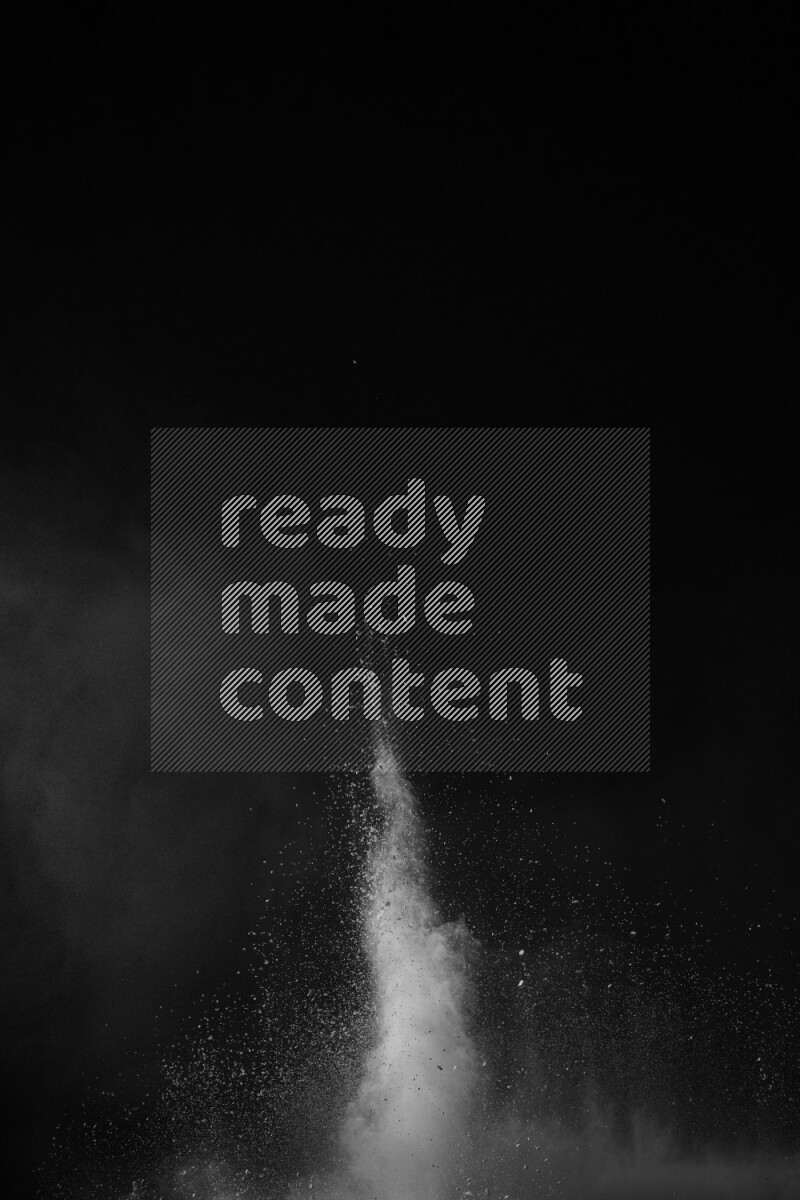 A side view of white powder explosion on black background
