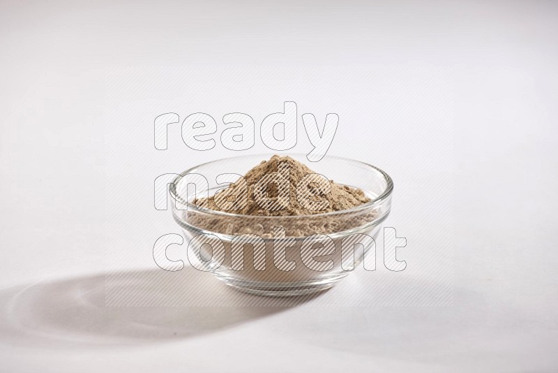 A glass bowl full of garlic powder on a white flooring in different angles