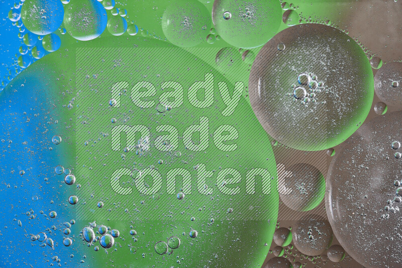 Close-ups of abstract oil bubbles on water surface in shades of brown, green and blue