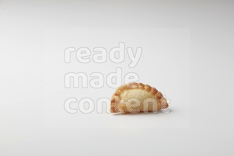 One fried sambosa on a white background