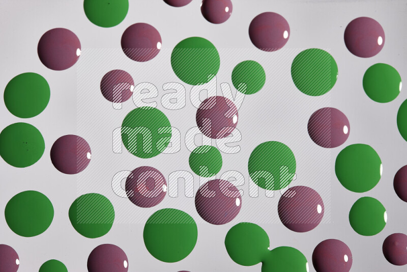 Close-ups of abstract purple and green paint droplets on the surface
