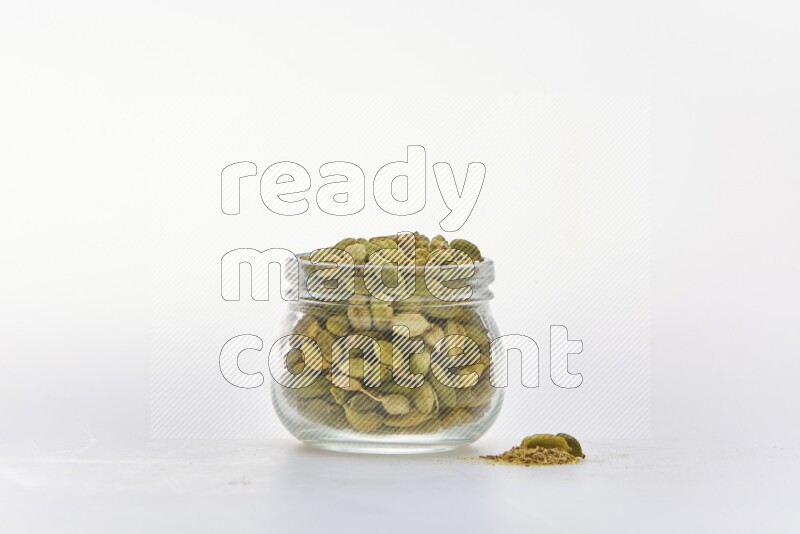 Cardamon in a container on white background
