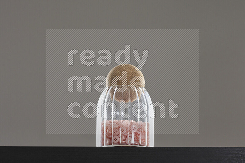 Buttons in a glass jar on black background