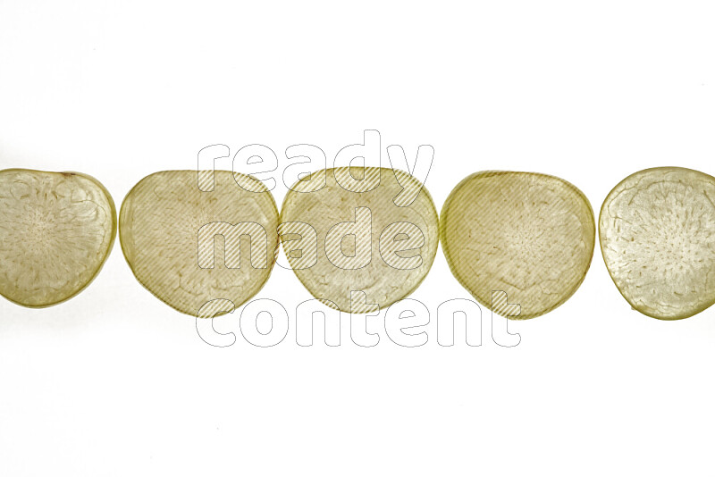 Plum slices on illuminated white background