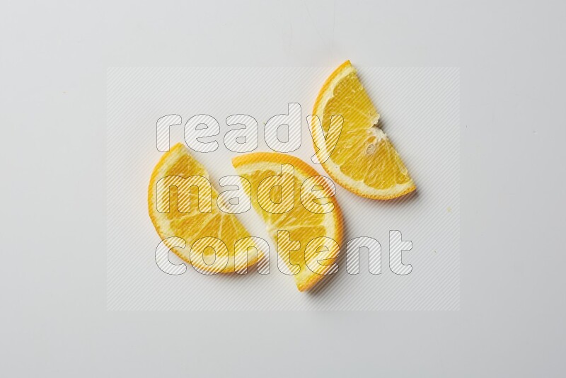 Three halves of an orange slices on white background