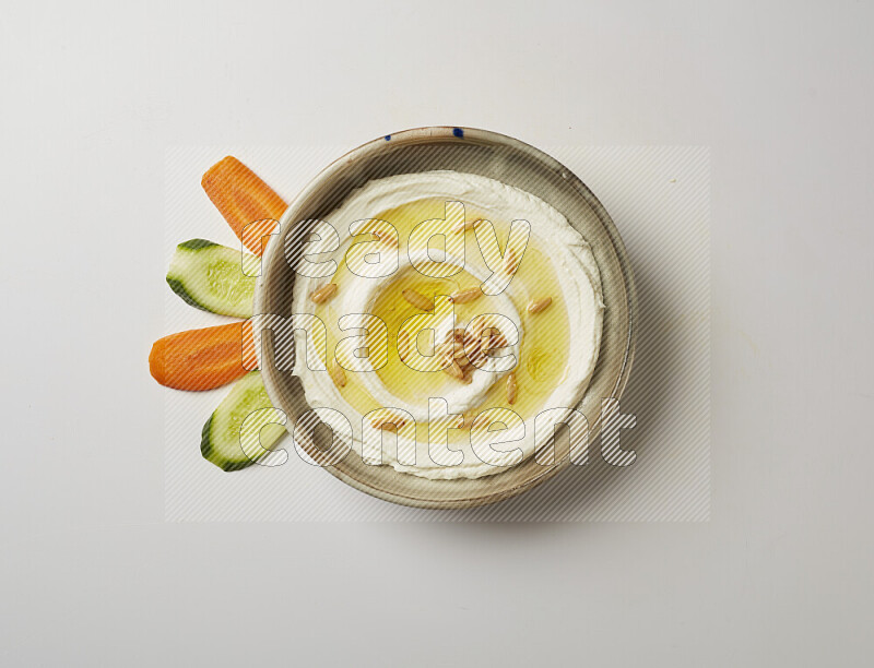 Lebnah garnished with pine nuts in a grey pottery plate on a white background