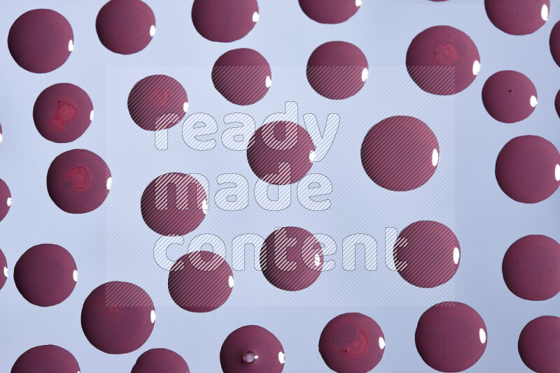 Close-ups of abstract purple paint droplets on the surface
