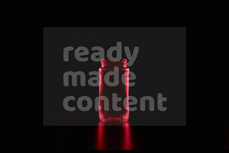 Glassware with rim light in red against black background