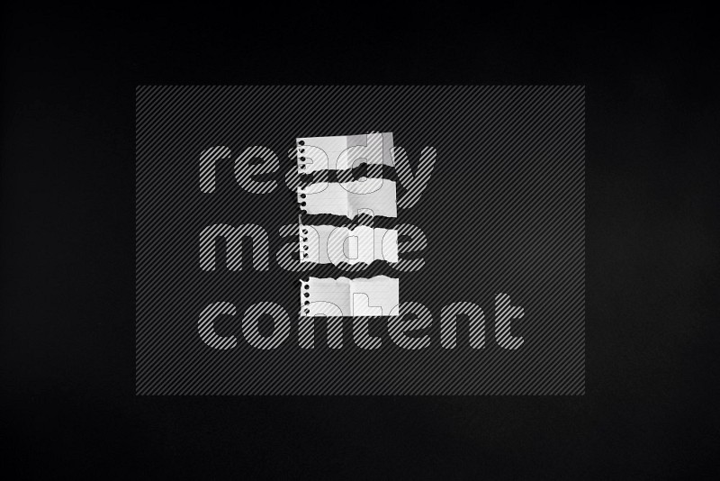 Ripped notebook sheet on black background
