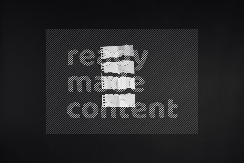 Ripped notebook sheet on black background