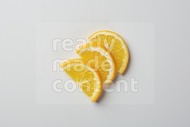 Three halves of an orange slices on white background