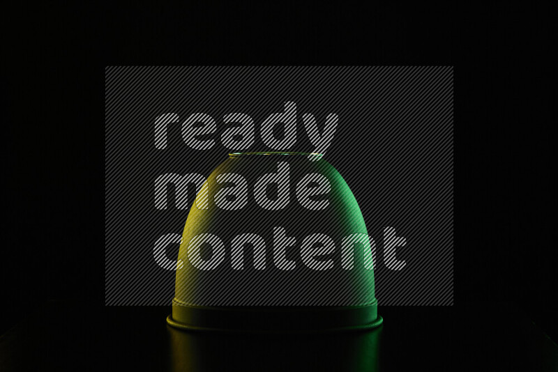 A reflector diffuser lamp shade dish with colored rim light against black background