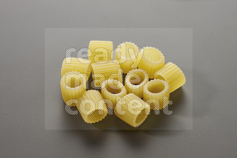 Big rings pasta on grey background