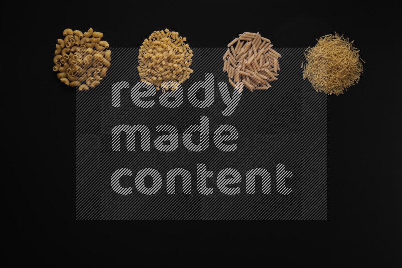 Different pasta types in 4 bunches on black background