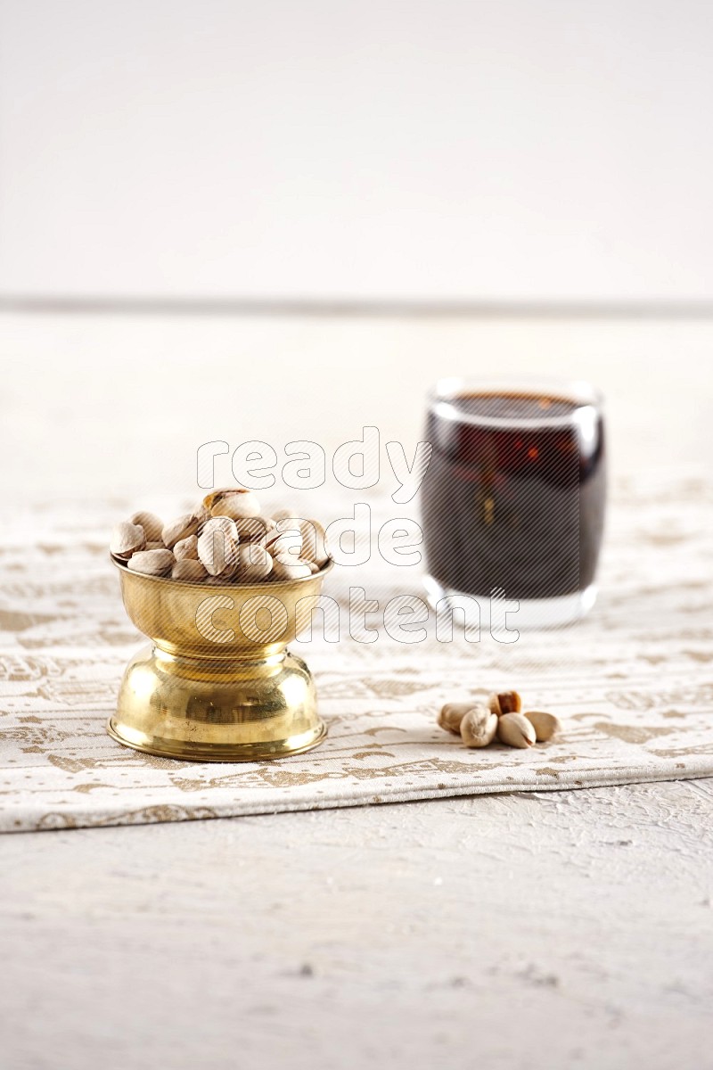 Nuts in a metal bowl with tamarind in a light setup