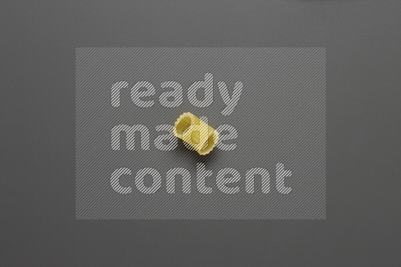 Elbow pasta on grey background