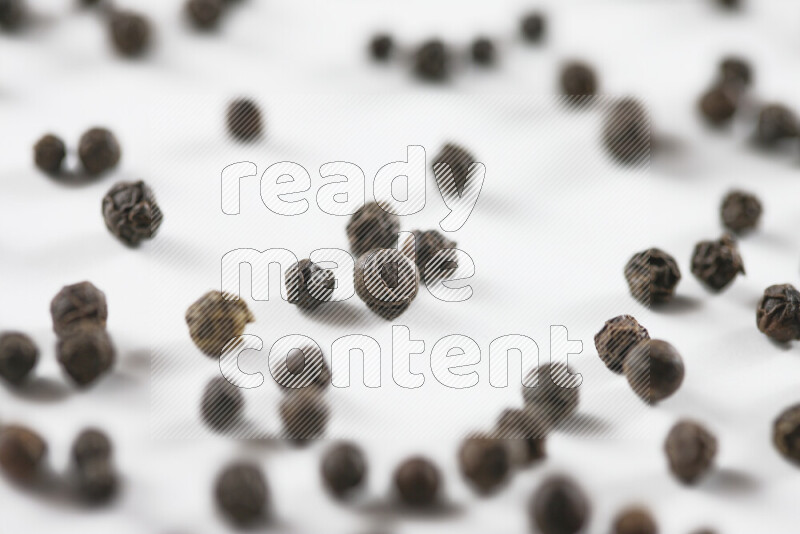 Black pepper beads on white background
