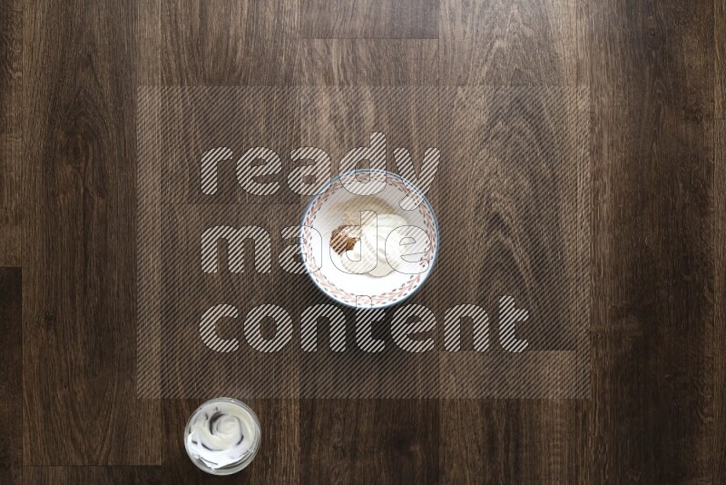 A bowl full of spices and salad dressing ingredients on wooden background