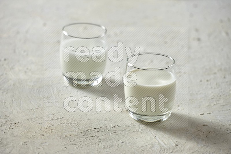 Cold drinks in a glass cup such as water, tamarind, qamar eldin, sobia, milk and hibiscus on textured white background