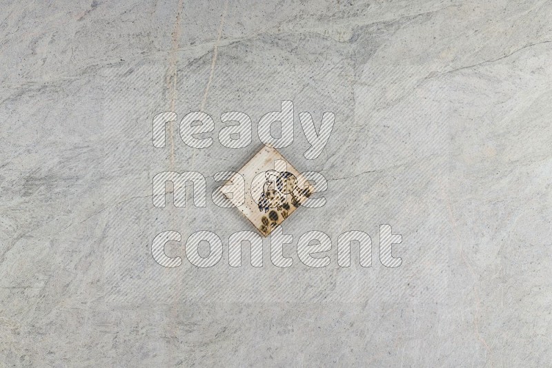 Top View Shot Of A Pottery Coaster tile On Grey Marble Flooring