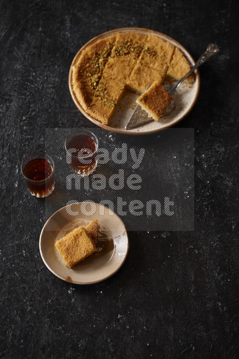 konafa with tea in a dark setup