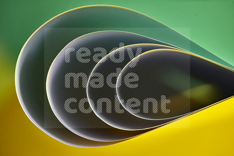 An abstract art of paper folded into smooth curves in green and yellow gradients