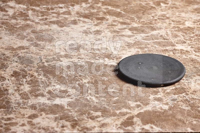 Flat Pottery Plate Coaster on Beige Marble Flooring, 45 degrees