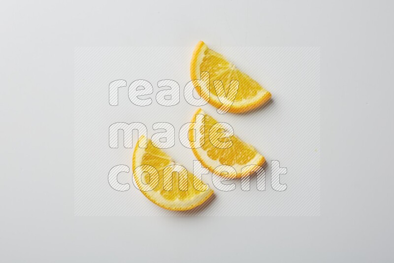 Three halves of an orange slices on white background