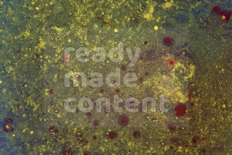 تلتقط الصورة تناثرا للطلاء الأصفر والأحمر علي خلفية زرقاء