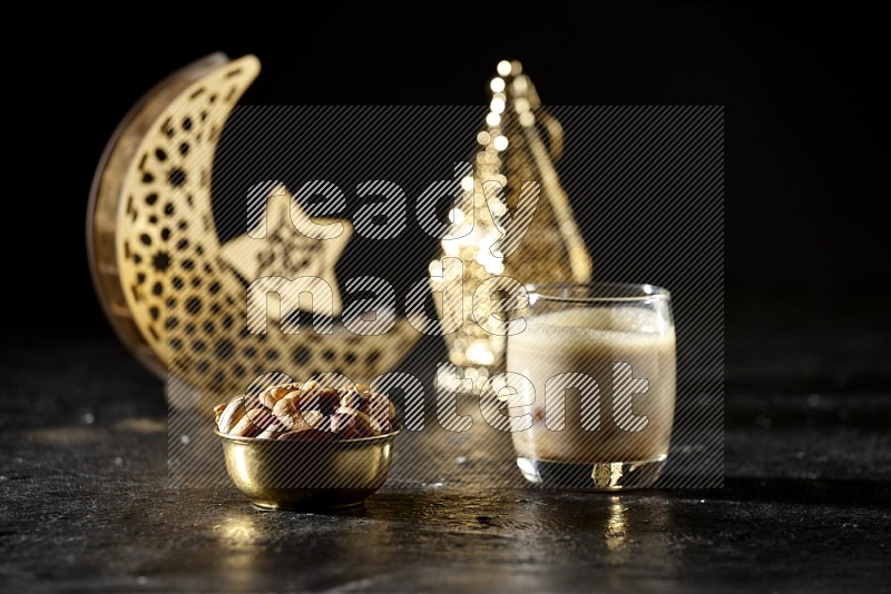 Nuts in a metal bowl with Nuts smoothie beside golden lanterns in a dark setup