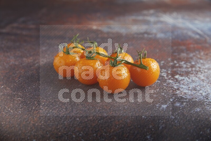 Orange cherry tomato vein on reddish rustic metal background 45 degree